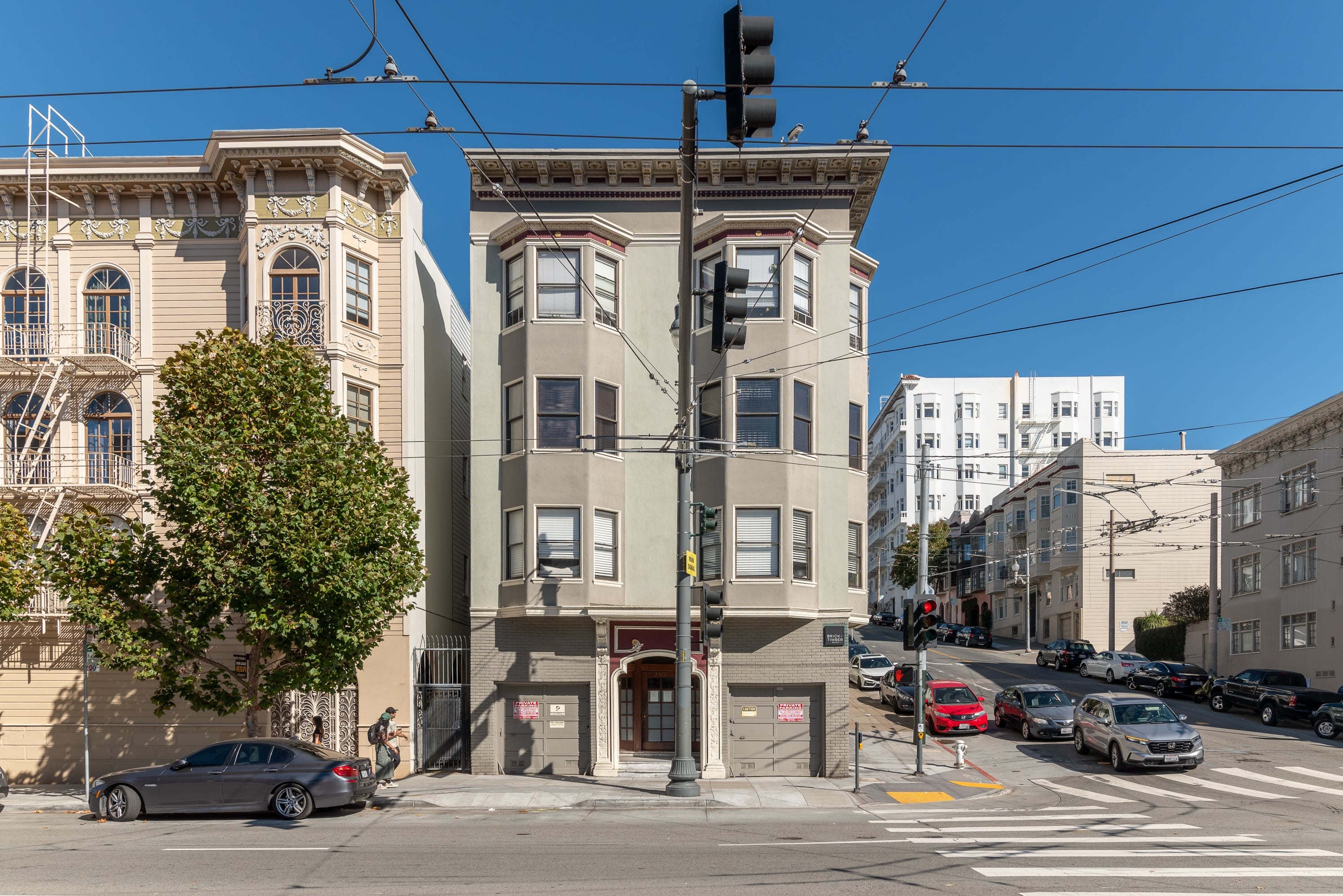 A street view of a city with cars and buildings.